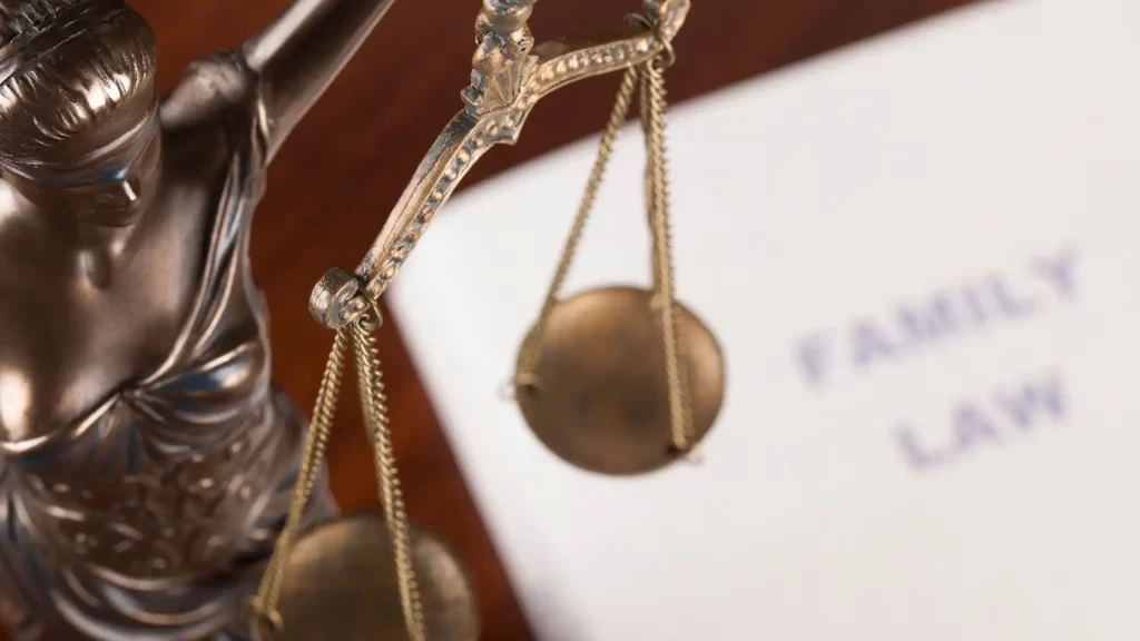 lady justice in the foreground and a family law paper placed on the background