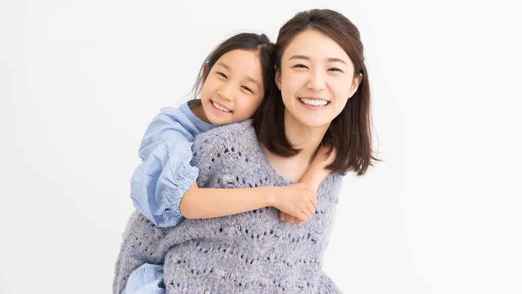 a parent and a child smiling